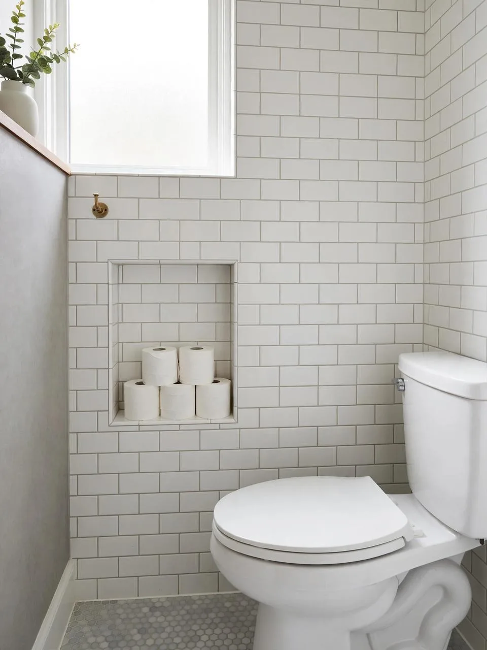 Recessed shelf between wall studs holding toilet paper